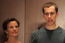 Shane Bauer addresses a press conference while Sarah Shourd looks on, in 2011