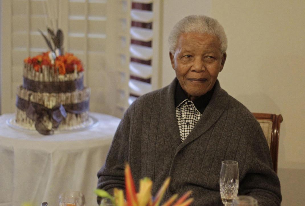 FILE - In this Wednesday, July 18, 2012 file photo, former South African President Nelson Mandela celebrates his 94th birthday with family in Qunu, South Africa. Mandela was taken to a hospital Saturday to be treated for a recurrence of a lung infection and is in
