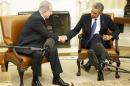 Netanyahu shakes hands with Obama as they sit down to meet in the Oval Office of the White House in Washington