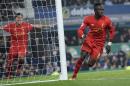 Liverpool's Senegalese midfielder Sadio Mane celebrates scoring his team's first goal during the English Premier League football match between Everton and Liverpool at Goodison Park in Liverpool, north west England on December 19, 2016