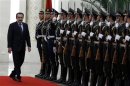 Kazakhstan's Prime Minister Masimov inspects an honour guard during an official welcoming ceremony in the Great Hall of the People in Beijing