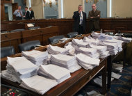 FILE - This May 15, 2013 file photo shows stacks of paperwork awaiting members of the House Agriculture Committee on Capitol Hill in Washington as it meets to consider proposals to the 2013 Farm Bill. Members of the House and Senate are scheduled to begin long-awaited negotiations Wednesday, Oct. 30, on the five-year, roughly $500 billion farm bill. If they don't finish it dairy supports could expire at the end of the year, sending the price of a gallon of milk skyward, and a contentious debate over food stamps could spill into election season. (AP Photo/J. Scott Applewhite, File)