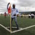 Former Cameroon soccer player Roger Milla dances at the corner flag after meeting young Kenyan players in the capital Nairobi