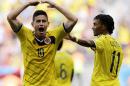 Colombia's James Rodriguez (10) celebrates with teammate Colombia's Juan Cuadrado after scoring his side's first goal during the group C World Cup soccer match between Colombia and Ivory Coast at the Estadio Nacional in Brasilia, Brazil, Thursday, June 19, 2014. (AP Photo/Fernando Llano)