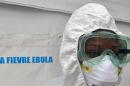 A health worker poses inside a tent in the Ebola treatment unit being preventively set up to host potential Ebola patients at the University Hospital of Yopougon, on October 17, 2014