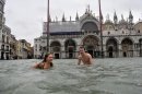 Photos: Tourists take a swim in flooded Venice