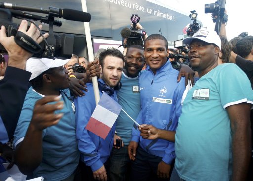 France's national soccer team player Malouda poses with fans after arriving in Donetsk