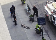 New York City police approach the lifeless body of Jeffrey Johnson lying on a sidewalk near the Empire State Building in New York following a shooting Friday, Aug. 24, 2012. Police say 58-year-old Johnson, who was laid off from a nearby shop in 2011, shot a former colleague to death near the iconic skyscraper, then randomly opened fire on people nearby before firing on police. New York City Mayor Michael Bloomberg said some of the victims may have been hit by police bullets as police and the gunman exchanged fire. (AP Photo/Guillermo Ratzlaff)