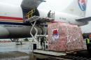 Workers unload medical supplies, coming from China and worth 4.9 million USD, for countries hit by the Ebola outbreak from an airplane at the Conakry airport on August 11, 2014