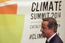 Britain's PM Cameron walks past a sign after speaking at the Climate Summit at the U.N. headquarters in New York