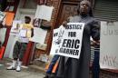 Demonstrators stand during the "We Will Not Go Back" march and rally for Eric Garner at the site where he died after being put in a choke hold by a New York City police officer, in New York