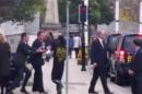 A still image taken from video shows a man approaching Britain's Prime Minister David Cameron as he leaves a news conference in Leeds, northern England
