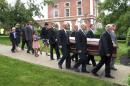 The casket of the late U.S. Sen. Jim Jeffords is carried from a church in Rutland, Vt., on Friday Aug. 22, 2014, followed by Jeffords' two children, Laura and Leonard and their families. Jeffords died Monday in Washington at age 80. Jeffords was known nationally for leaving the Republican Party in 2001, switching control of the Senate to the Democrats. (AP Photo/Wilson Ring)