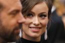 Olivia Wilde, wearing Lorraine Schwartz drop earrings, and Jason Sudeikis arrive at the 86th Academy Awards in Hollywood