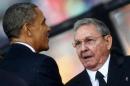 US President Obama greets Cuban President Castro at the memorial service for Nelson Mandela in Johannesburg