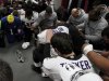 Baltimore Raven players pray in the dressing room around the AFC Championship Trophy after defeating the New England Patriots in the NFL AFC Championship football game in Foxborough