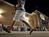 Shoppers stand in line outside a Best Buy department store before the store's opening at midnight for a Black Friday sale, Thursday, Nov. 22, 2012, in Arlington, Texas. Despite a surge of resistance as the sales drew near, with scolding editorials and protests by retail employees and reminders of frantic tramplings past, Black Friday's grip on America may have been proven stronger than ever. (AP Photo/Tony Gutierrez)