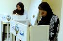 Kuwaiti women cast their votes during parliamentary election in a polling station in Kuwait City