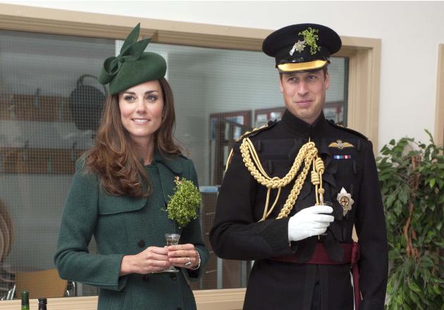 Britain's Prince William and his wife Catherine, Duchess of Cambridge hold their drinks during a visit to the 1st Battalion Irish Guards for a St Patrick's Day Parade at Mons Barracks in Aldershot