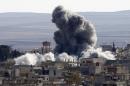 An explosion following an air strike is seen in western Kobani neighbourhood