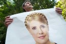 A supporter of former Ukrainian Prime Minister Yulia Tymoshenko holds a poster of her in front of a state-run hospital in Kharkiv, Ukraine, Wednesday May 9, 2012. Tymoshenko, Ukraine's imprisoned former prime minister, was moved Wednesday from jail to this hospital for treatment of a severe back condition under the supervision of a German doctor. The move was likely to allay at least some Western concerns over Tymoshenko's health and handling in prison. Top EU officials and some EU governments have vowed to boycott the European football championship matches co-hosted by Ukraine in June, and Ukraine had to cancel a regional cooperation summit this weekend after most heads of central and eastern European states canceled their visits over the Tymoshenko case. (AP Photo/dapd/ Alexey Furman)