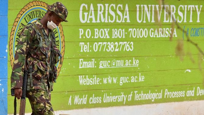 A Kenya Defence forces soldier walks past the front entrance of Moi University Garissa on April 3, 2015 after a massacre of students by Somalia&#39;s Al-Qaeda-linked Shebab fighters