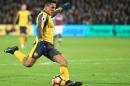 Arsenal's Alexis Sanchez shoots to score the team's second goal during the match against West Ham United in east London on December 3, 2016