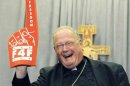 Archbishop Dolan holds up a foam finger promoting "A Fortnight for Freedom" conference sponsored by the Catholic church, following a afternoon session during the U.S. Conference of Catholic Bishops Annual Spring Assembly in Atlanta