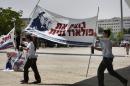 Israeli youth demonstrators hold a banner with an image of Jonathan Pollard, a Jewish American who was jailed for life in 1987 on charges of spying on the United States, during a demonstration for his release in Jerusalem on July 13, 2010