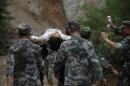 Chinese rescuers carry an injuried resident after an earthquake hit an area of Ludian county in Zhaotong on August 3, 2014