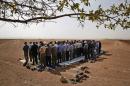 Turkish Kurds in the outskirts of Suruc, on the Turkey-Syria border, offer their Friday prayers as they gather to support Syrian Kurds over the border in nearby Kobani, Syria, where fighting between Syrian Kurds and the militants of Islamic State group intensified, Friday, Oct. 10, 2014. Kobani, also known as Ayn Arab, and its surrounding areas, has been under assault by extremists of the Islamic State group since mid-September and is being defended by Kurdish fighters. (AP Photo/Lefteris Pitarakis)