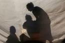 Displaced Iraqis, who fled the Islamic State stronghold of Mosul, are seen inside a tent at Khazer camp