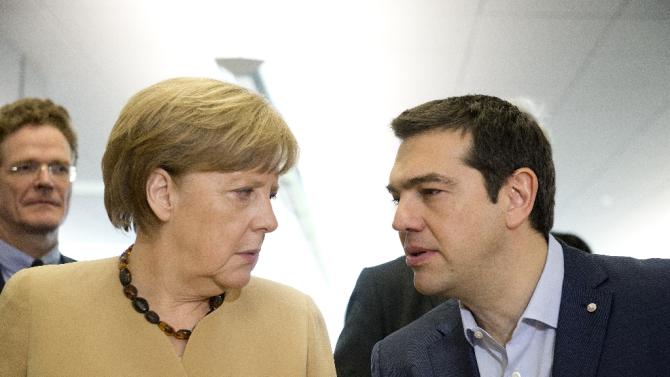 German chancellor Angela Merkel (L) talks with Greek Prime Minister Alexis Tsipras at the EU eastern Partnership Summit in Riga, on May 22, 2015