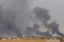 Smoke rising above the Baiji area as Iraqi pro-government forces clash with Islamic State group jihadists, on April 16, 2015