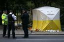 Police officers stand near a forensics tent after a knife attack in Russell Square in London