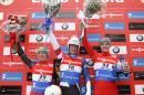 Tucker West, of the United States, (18) celebrates his win in the men's luge World Cup event with second-place finisher Wolfgang Kindl, left, of Austria, and third-place finisher Dominik Fischnaller, of Italy, Friday, Dec. 5, 2014, in Lake Placid, N.Y. (AP Photo/Mike Groll)