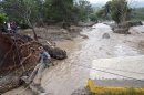A man uses a makeshift zip line to cross a river after a bridge collapsed under the force of the rains caused by Tropical Storm Manuel near the town of Petaquillas, Mexico, Wednesday, Sept. 18, 2013. The death toll from devastating twin storms climbed to 80 on Wednesday as isolated areas reported to the outside world. Mexican officials said that a massive landslide in the mountains north of Acapulco could drive the number of confirmed dead even higher. (AP Photo/Alejandrino Gonzalez)