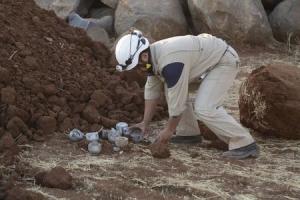 A civil defence member gathers unexploded cluster bomblets &hellip;