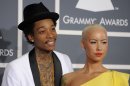 FILE - This Feb. 12, 2012 file photo shows Wiz Khalifa, left, and Amber Rose at the 54th annual Grammy Awards in Los Angeles. Khalifa says the preparation of becoming a first-time father and husband has helped put him in a more mature musical state of mind. "I'm at a different point of my life," said Khalifa, whose sophomore album, "O.N.I.F.C.," debuted at No. 2 on Billboard's 200 albums chart Wednesday with more than 141,000 copies sold, according to Nielsen Scan. (AP Photo/Chris Pizzello, file)