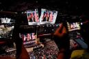 Republican presidential nominee Donald Trump is seen on video monitors as people take photographs during the Republican National Convention in Cleveland, Ohio
