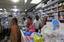 A customer buys medication at a pharmacy in Khartoum