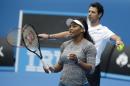 Serena Williams of the US gestures with her coach Patrick Mouratoglou to a hitting partner during a practice session on Rod Laver Arena ahead of the Australian Open tennis championship in Melbourne, Australia, Thursday, Jan. 15, 2015. (AP Photo/Mark Baker)