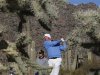 Kuchar of the U.S. tees off on the 16th hole as Mahan of the U.S. watches in the background during the championship match of the WGC-Accenture Match Play Championship golf tournament in Marana