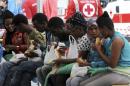 Migrants eat food they received after disembarking from the Norwegian cargo ship Siem Pilot after they were rescued in the Mediterranean Sea, at Palermo harbor, Italy, Wednesday, June 24, 2015. Conflict and poverty have driven more than 100,000 migrants to Europe so far this year, and almost 2,000 have died or gone missing on the perilous sea journey. (AP Photo/Alessandro Fucarini)