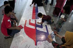 Visitors write on a banner carrying messages for the&nbsp;&hellip;