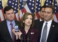 Rep. Nan Hayworth, R-N.Y., center, accompanied by, from left, Rep. Todd Rokita, R-Ind., Rep. Austin Scott, R-G., and Rep. Rick Berg, R-N.D., shows a photo of her children, Will and Jack, during a House Republican freshmen news conference on Capitol Hill in Washington, Thursday, Nov. 17, 2011, to discuss a Balanced Budget Amendment. (AP Photo/Harry Hamburg)