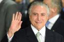 Brazilian acting President Michel Temer gestures during the inauguration ceremony of the new ministers at Planalto Palace, in Brasilia, on May 12, 2016