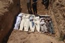 FILE- This Aug. 21, 2013, file image provided by by Shaam News Network, which has been authenticated based on its contents and other AP reporting, purports to show several bodies being buried during a funeral in a suburb of Damascus, Syria. A senior administration official said Sunday, Aug. 25, 2013, that there is 