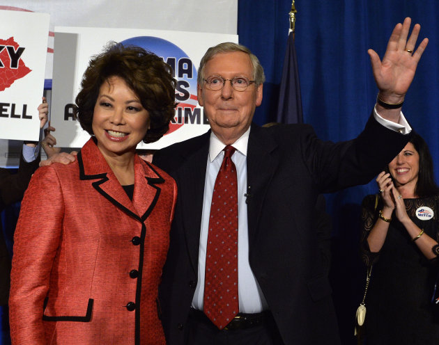 Kentucky Sen. Mitch McConnell and his wife, Elaine Chao, wave to his supporters after his victory in the Republican primary on May 20. (Timothy D. Easley/AP)