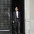 Greek Financial Minister Yannis Stournaras walks off the Premier's office after a meeting with the Greek Prime Minister and the Troika in Athens